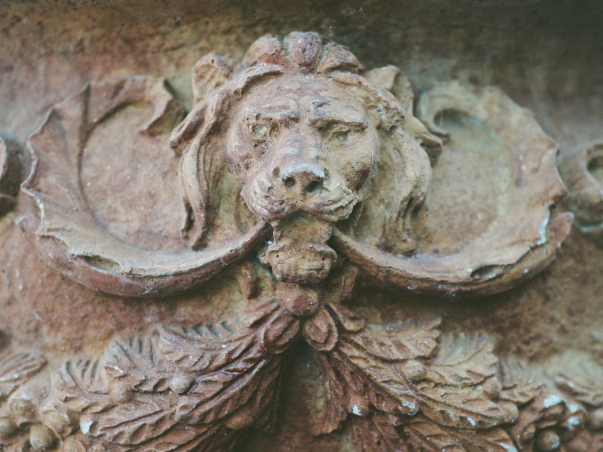a carving of a lion made out of clay